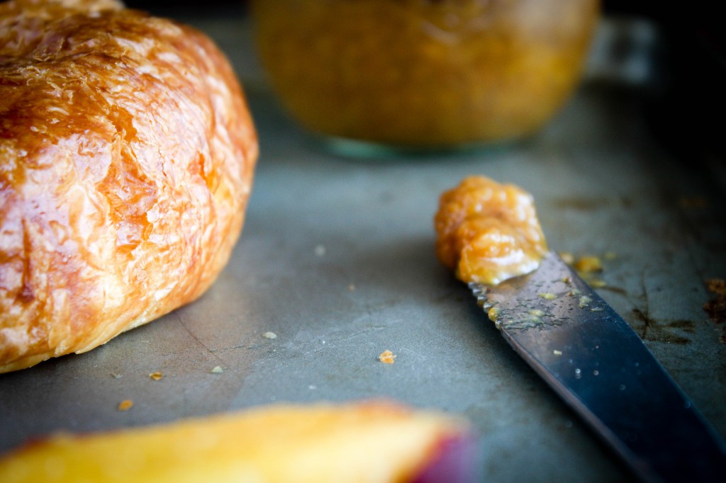 peach butter on knife peach in front